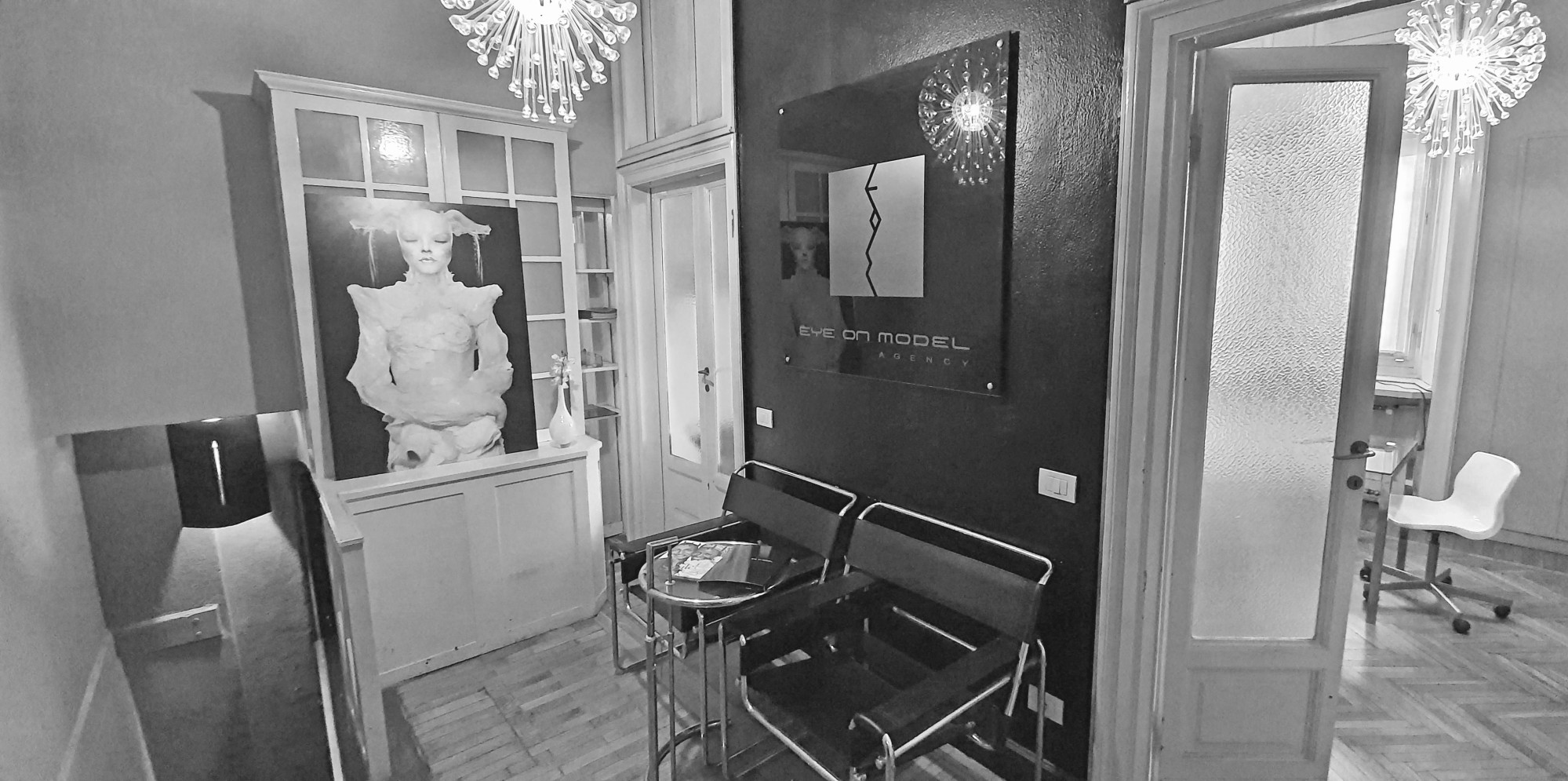 Eye On Model reception area with classical sculpture and agency logo at the Milan headquarters